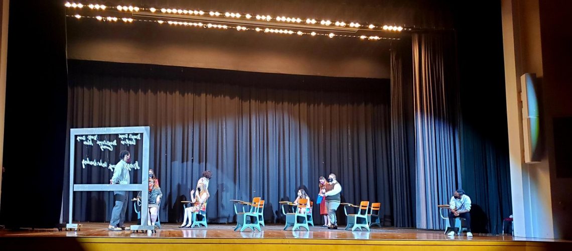 Students rehearsing play on stage