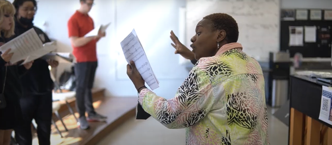 Watson leading students in sing-along masterclass at Harding Fine Arts Academy